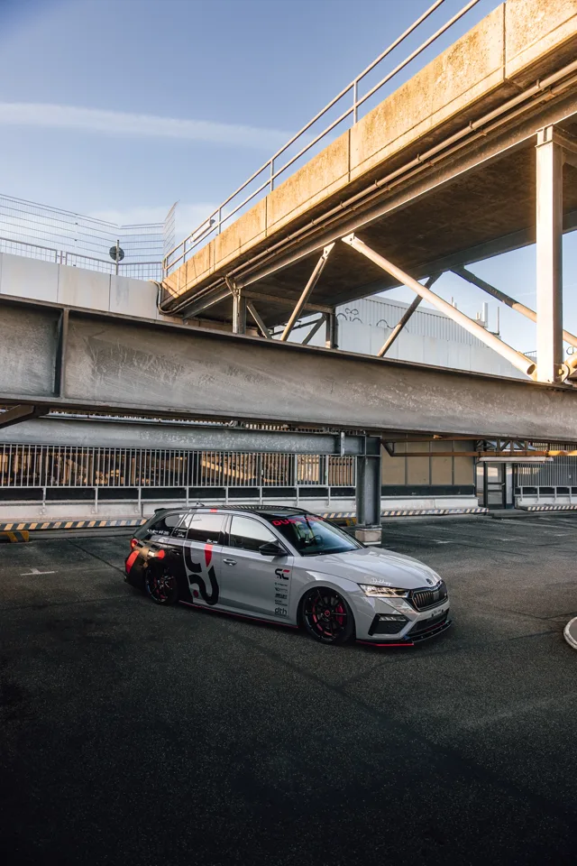 Front three-quarter view of the custom Octavia RS beneath a concrete bridge