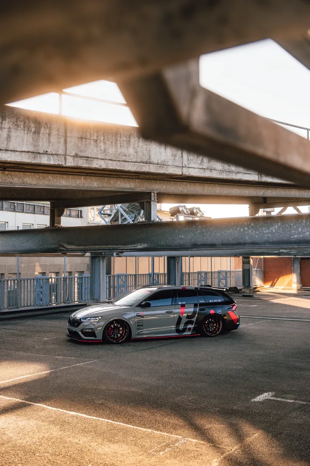 Side profile of the Octavia RS beneath concrete and steel structures