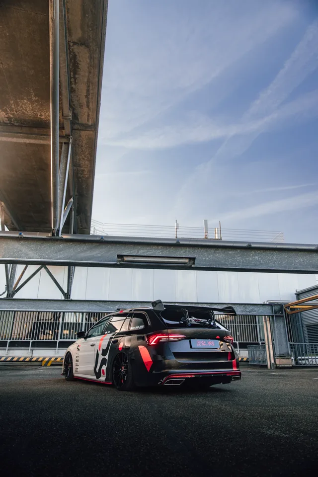 Rear three-quarter angle showing the Octavia RS’s SC wrap and red wheel details